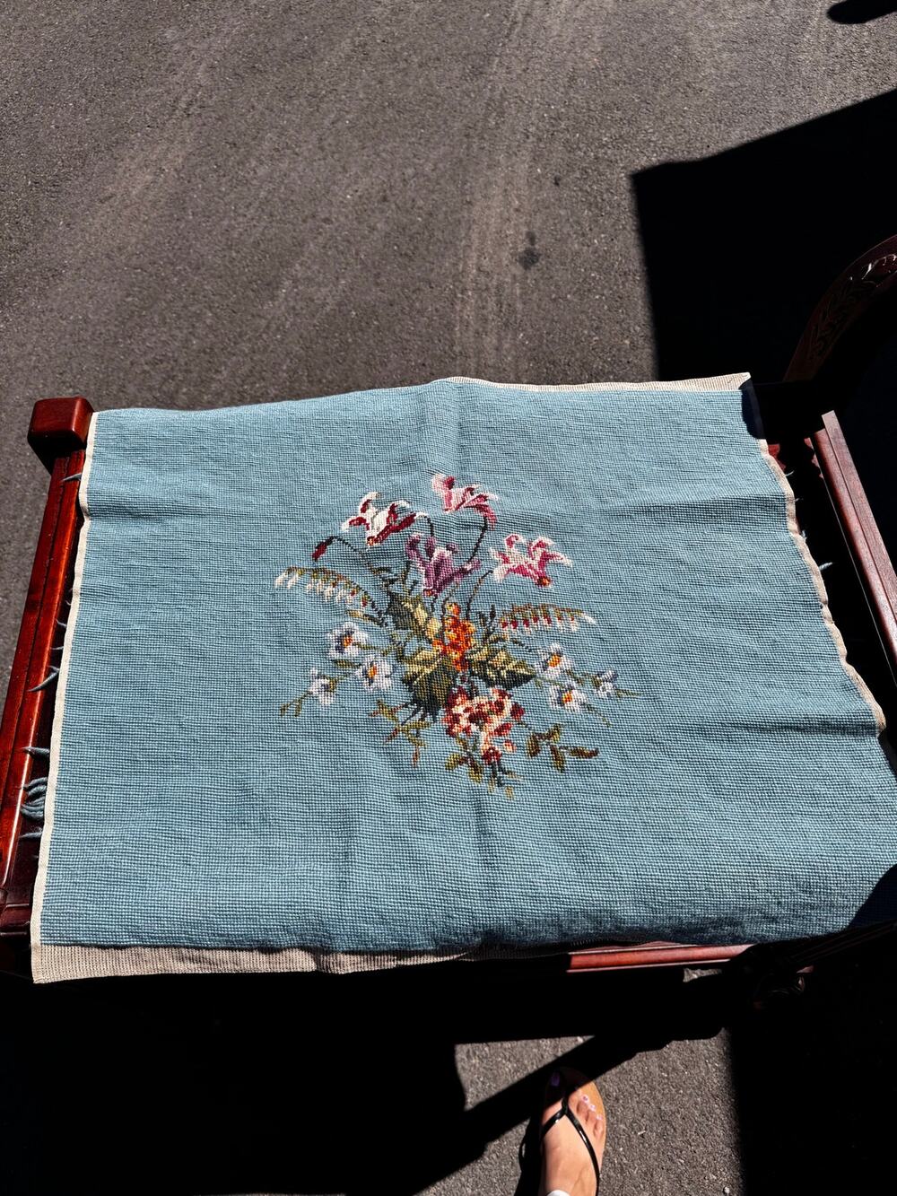 completed vintage needlepoint tapestry central floral bouquet light background
